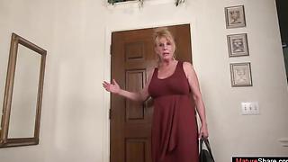 Blonde mature woman stripping and playing with a sex toy